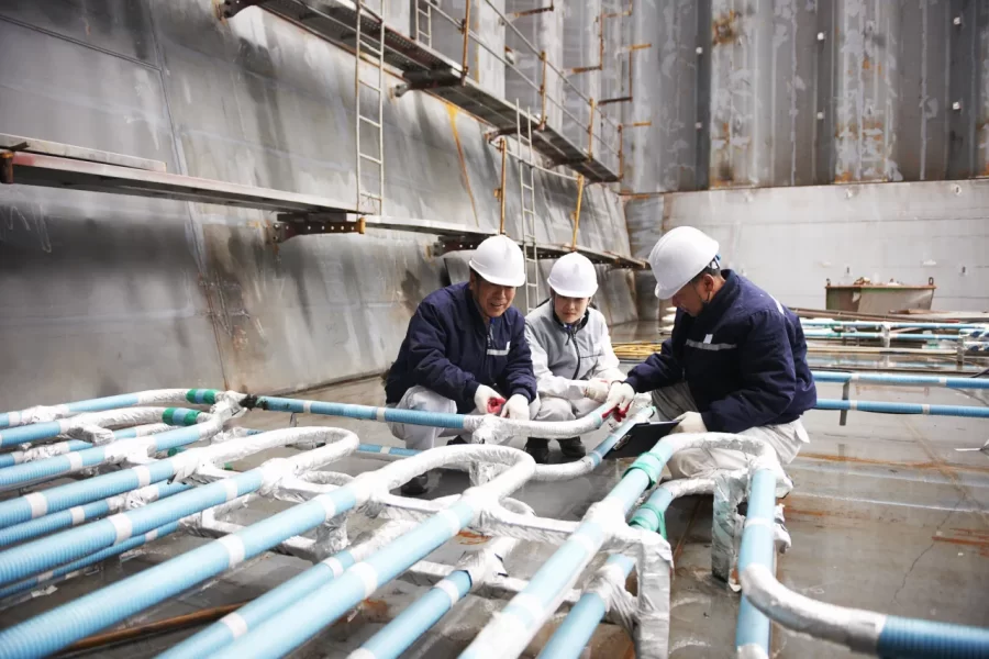 workers-checking-pipework-on-container-ship-at-shi-2022-03-08-00-18-56-utc